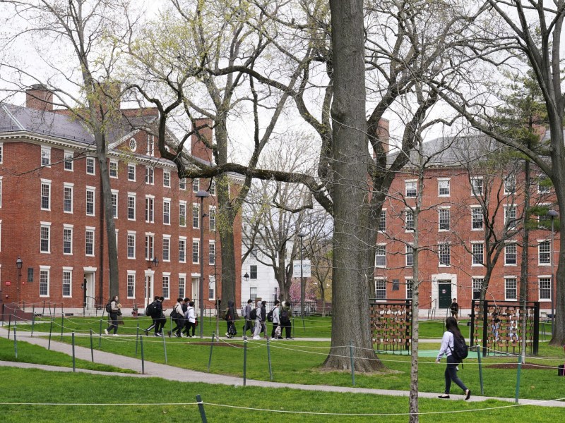 The College Board, the non-profit organization that administers the SAT exam, caved to pressure from the Trump administration, scrapping its race-neutral Landscape tool. The decision undermines fairness and abandons high-achieving low-income students. Here, students walk through Harvard Yard, April 27, 2022, on the Harvard campus in Cambridge, Mass.