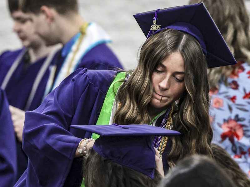 Sydney Tucker, a a Kentucky Wesleyan College psychology major, helps fellow graduate Kerison Bailey attach her cap securely as the two prepare for the college's commencement exercises at Owensboro Christian Church, Saturday, May 3,, 2025, in Owensboro, Ky.