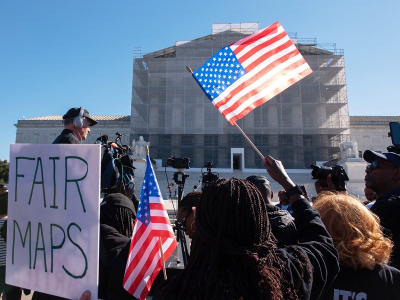 Voting rights activists gather outside the Supreme Court in Washington, early Wednesday, Oct. 15, 2025, as the justices prepared to hear a major Republican-led challenge to the Voting Rights Act, the centerpiece legislation of the Civil Rights Movement.