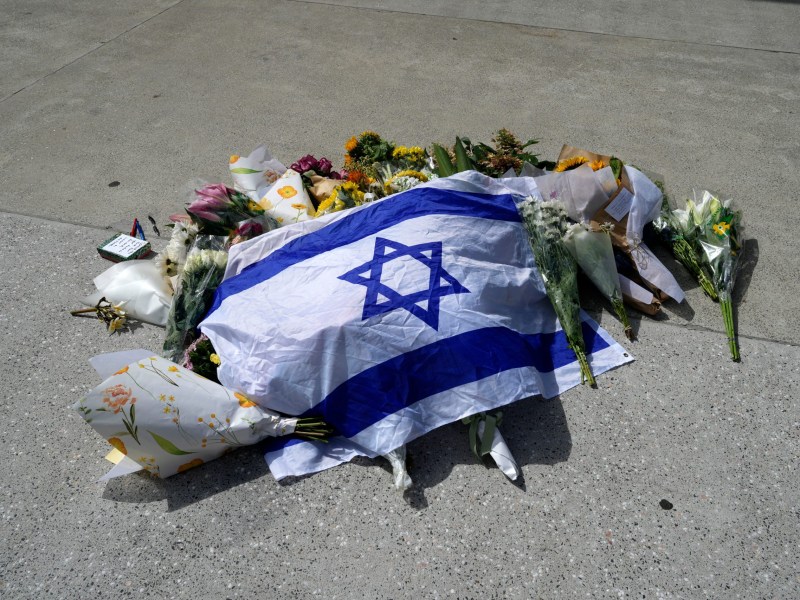 An Israeli flag lies at a memorial outside Bondi Pavilion at Sydney's Bondi Beach, on Monday, a day after 15 were shot dead at a Hanukkah celebration.