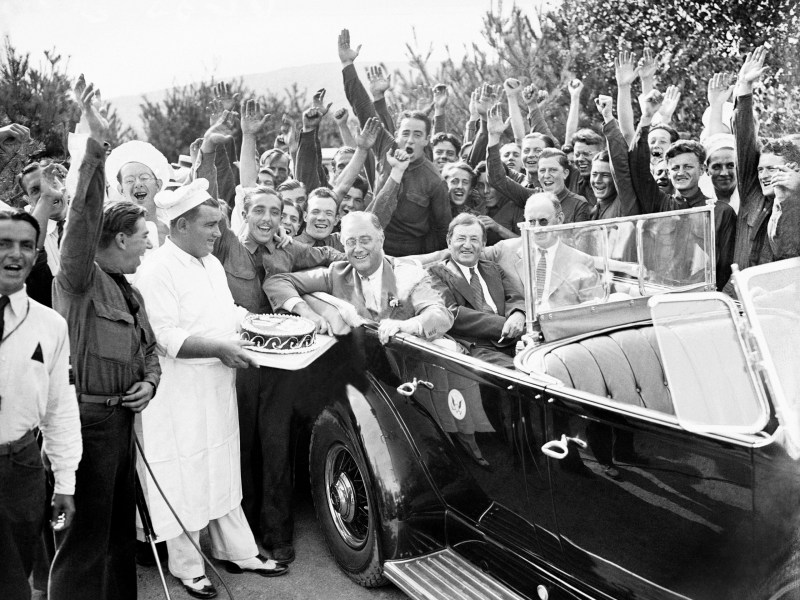 National Service Model: President Franklin D. Roosevelt is presented with a cake from the chefs of the Civilian Conservation Corps in his honor during his inspection visit at their Bear Mountain camp in New York, Aug. 27, 1933.