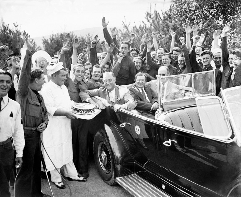National Service Model: President Franklin D. Roosevelt is presented with a cake from the chefs of the Civilian Conservation Corps in his honor during his inspection visit at their Bear Mountain camp in New York, Aug. 27, 1933.