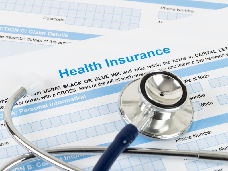 health care plan: Health insurance application form with stethoscope and calculator