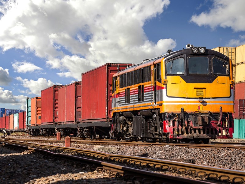 Container Freight Train with cloudy sky.