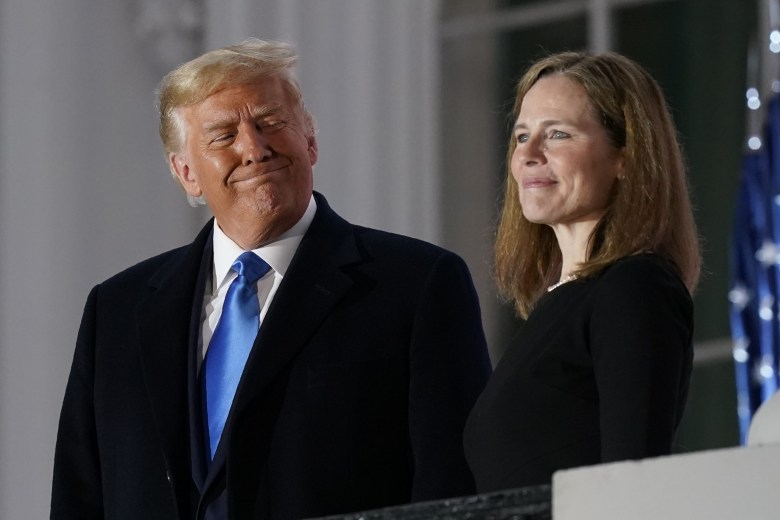 President Donald Trump and Amy Coney Barrett stand on the Blue Room Balcony of the White House after Barrett took her oath as a Supreme Court justice on Oct. 26, 2020.