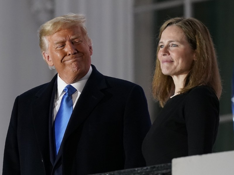 President Donald Trump and Amy Coney Barrett stand on the Blue Room Balcony of the White House after Barrett took her oath as a Supreme Court justice on Oct. 26, 2020.